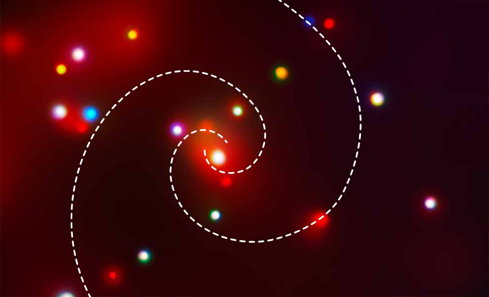 Color image of several wavelength-bands of X-ray light from the spiral galaxy M74 (the Phantom Galaxy). Although the perspective and field of view are the same as in the other images, this image is very different from the visible, mid-infrared, and ultraviolet images in terms of color, visible structure, and detail. Scattered across the image are glowing circles of various colors: bright red, bright blue, yellowish-orange, and white. The circles vary in size, but are typically much larger than the point-like stars in the visible and infrared images. They are somewhat fuzzy, but have more distinct outlines than the blue-white clumps in the ultraviolet image. The largest of these objects is located in the center of the image and appears to mark the core of the galaxy. It is bright white and is surrounded by a bright but diffuse red glow. This glow is present around some of the other objects and across the upper left portion of the image. Unlike in the visible, mid-infrared, and ultraviolet images, the spiral arms of the galaxy are not apparent in this image.